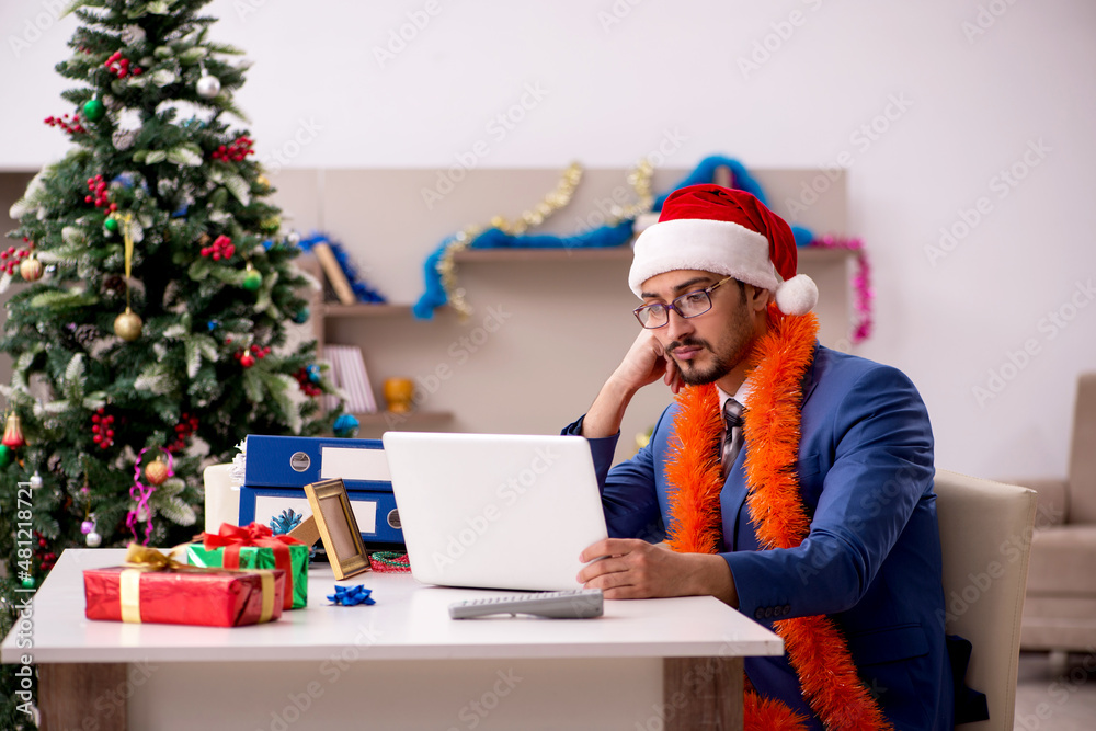 Young businessman working from home at Christmas eve Young businessman working from home at Christmas eve