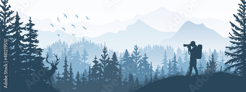 Photographer on meadow in forest take picture of deer. Silhouette of tree, man, animal, mountains. Wild nature landscape. Horizontal banner.