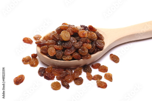 Pile raisins in wooden spoon isolated on white 