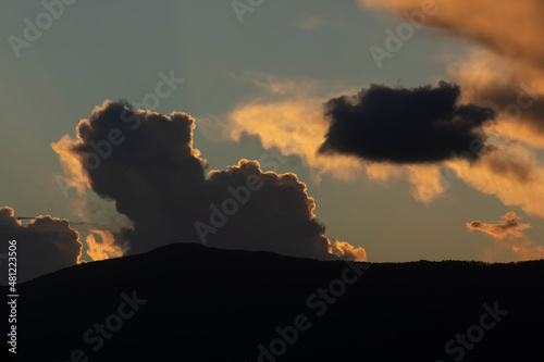 Sunset landscape formed by the hills, the clouds and the last lights, in front of the Garita da Vela, from Espasante, council of Ortigueira, Galicia, Spain photo