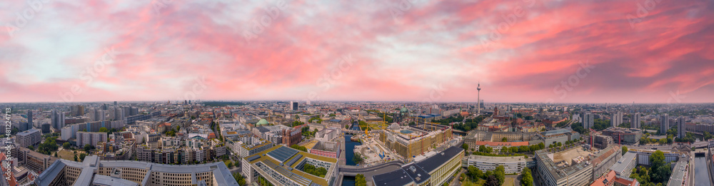 Panoramic aerial view of Berlin skyline at sunset with major city landmarks along Spree river, Germany from drone in summer season. Panoramic aerial view of Berlin skyline at sunset with major city landmarks along Spree river, Germany from drone in summer season.