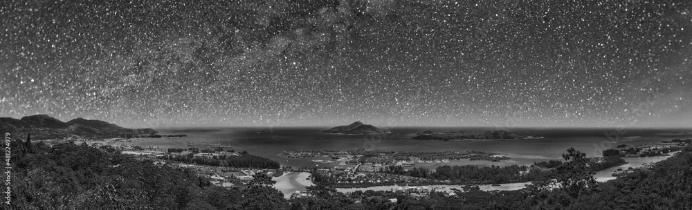 Panoramic aerial view of Eden Island and Mahe seascape from the hill on a starry night, Seychelles.