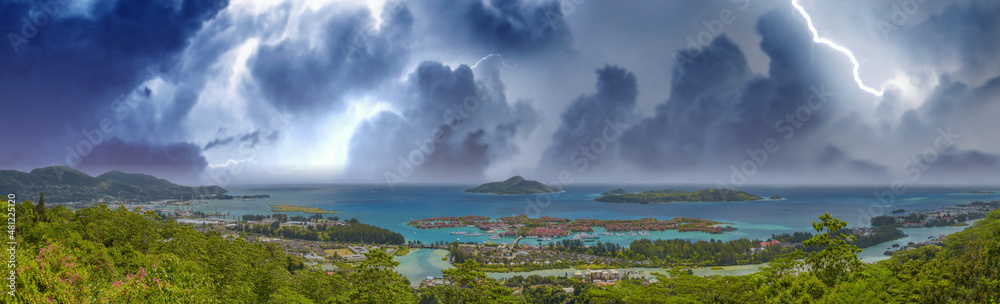 Panoramic aerial view of Eden Island and Mahe seascape from the hill during a storm, Seychelles. Panoramic aerial view of Eden Island and Mahe seascape from the hill during a storm, Seychelles.