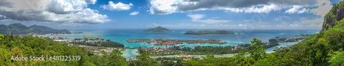 MAHE', SEYCHELLES - SEPTEMBER 15, 2017: Panoramic aerial view of Eden Island and Mahe seascape from the hill at sunset.