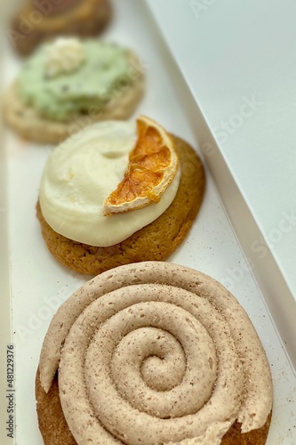 Gourmet cookies from Crumbl Cookies chain of bakeries. Churro,  Orange Roll, Mint Chip, Turtle giant cookies in a long box. Bakery specializes in weekly rotating menu of giant, high-quality cookies.