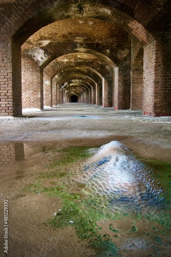 Fort Jefferson at Dry Tortugas National Park in the Florida Keys. Aging brick fort. Rainwater leaches calcium carbonate from the mortar, slowly depositing stalactites and stalagmites in the arches. photo