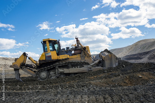 A bulldozer works at a gold mining site.