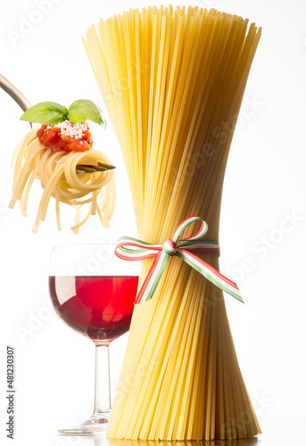 Spaghetti and glass of red wine on the white background