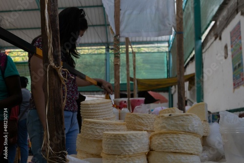 cheeses in the market. person shopping in the market price, buy and sell popular market. Cuzco market. Latin markets. sale of vegetables, meat and milk. farmers market. Peru.