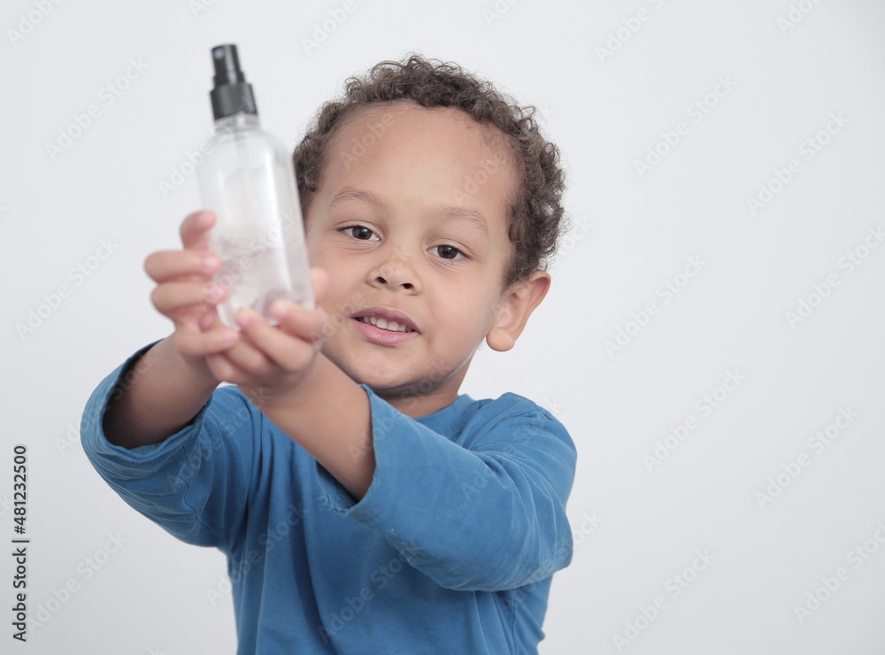 boy with spray bottle preventing coronavirus infection on white background stock photo boy with spray bottle preventing coronavirus infection on white background stock photo