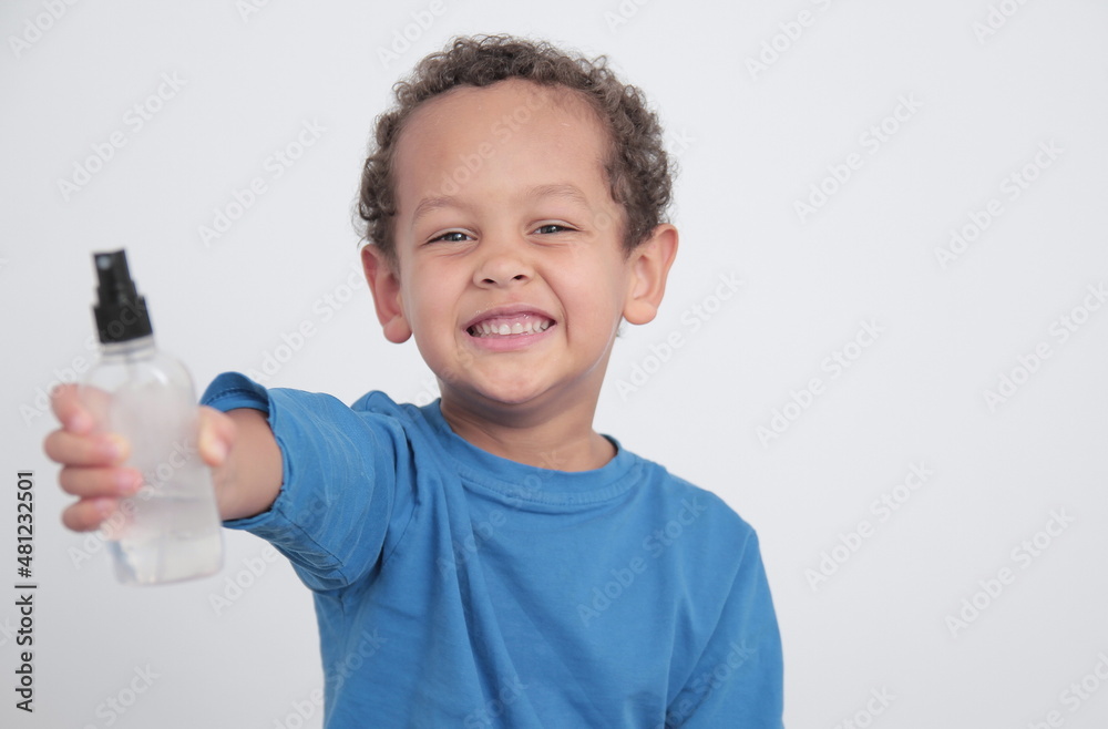 boy with spray bottle preventing coronavirus infection on white background stock photo boy with spray bottle preventing coronavirus infection on white background stock photo