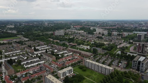 Aerial top view of a city in Holland, surrounded by houses, green trees and canal photo