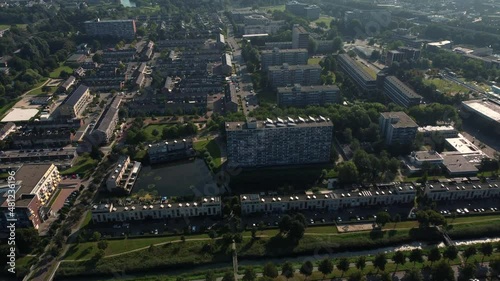 Aerial top view of a city in Holland, surrounded by houses, green trees and canal