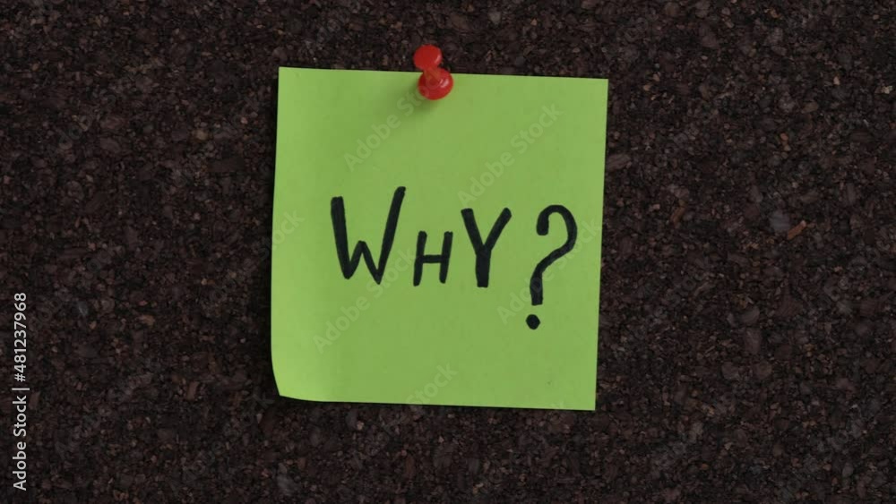 A sticky note with the Why question on it pinned to a cork board. Close up.