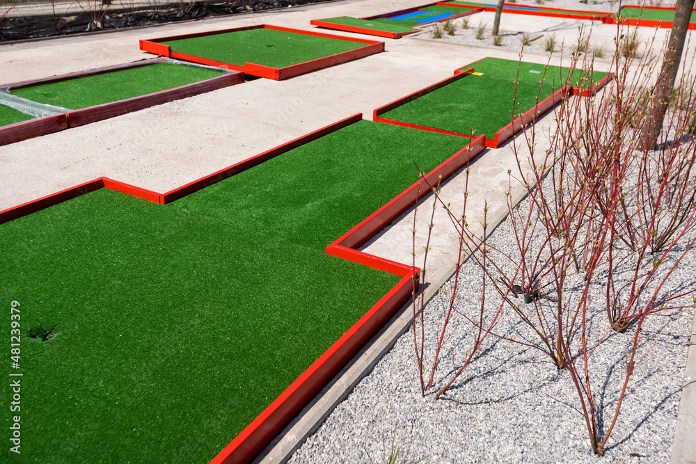 green artificial grass and rocks on miniature golf course