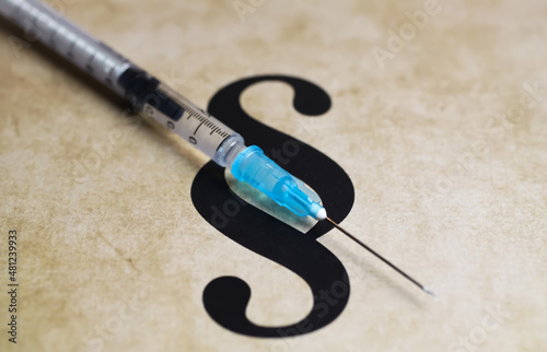 Closeup of paragraph symbol with vaccination injection syringe - euthanasia assisted suicide dying concept photo