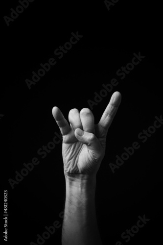 B+W image of hand demonstrating Chinese sign language letter T isolated against black background