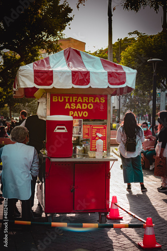 itinerant sale of butifarra in lima, peru. butiffara cart in latinoamerica park. merchants in the street and squares of lima Peru. sale of sausage in the squares.