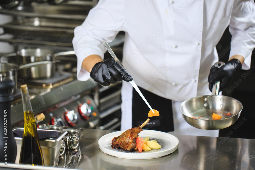 Chef Preparing Dish In Kitchen. Decorating Dish. Chef Preparing Dish In Kitchen. Decorating Dish.