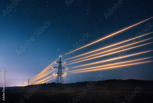 Electricity transmission towers with orange glowing wires the starry night sky Fototapet
