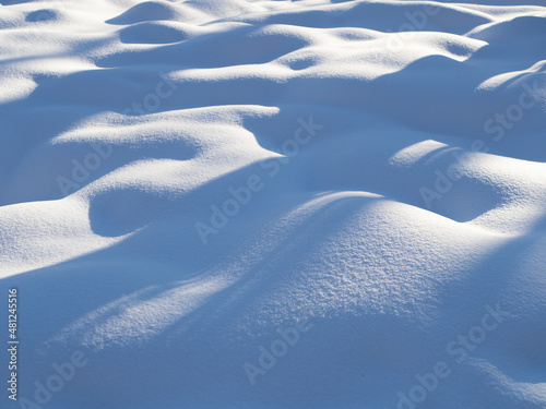 Beautiful sunny bright snow texture with shadows on sunny day in winter