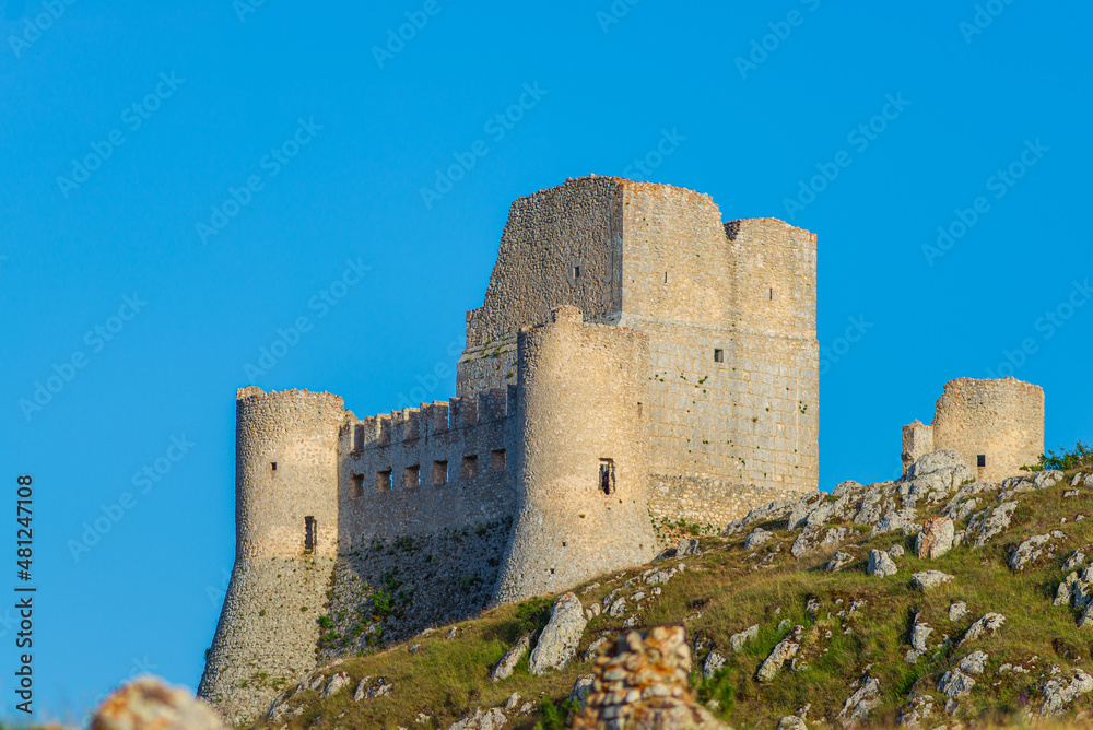 Castle ruins at Rocca Calascio italian travel destination, landmark in the Gran Sasso National Park, Abruzzo, Italy. Clear blue sky