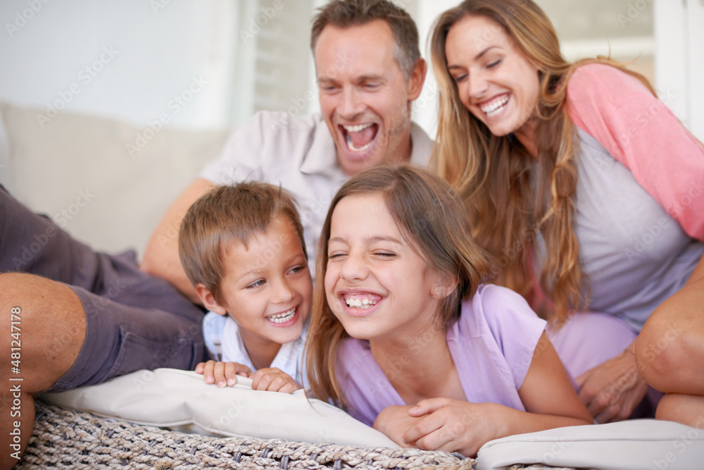 Attack of the tickle monsters. Shot of a happy young family playing together.