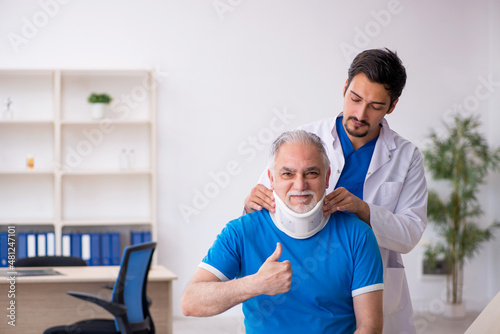 Old neck injured male patient visiting young male doctor