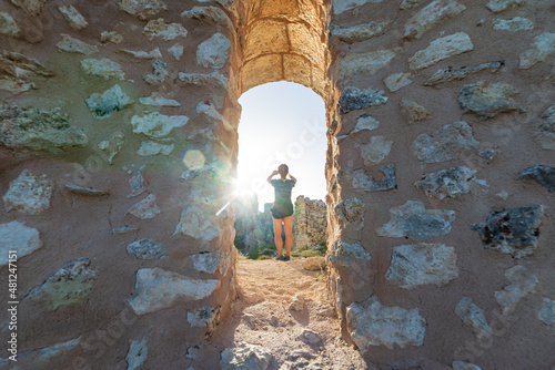 Fotografie, Obraz Woman selfie at castle ruins on mountain top at Rocca Calascio, italian travel destination, landmark in the Gran Sasso National Park, Abruzzo, Italy