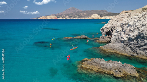 Aerial drone photo of women team of sport kayak in iconic beach and small cove of Tsigrado, Milos island, Cyclades, Greece photo