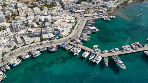 Aerial drone photo of picturesque village of Adamantas main port a natural calm sea bay and safe anchorage of yachts and sail boats in volcanic island of Milos, Cyclades, Greece