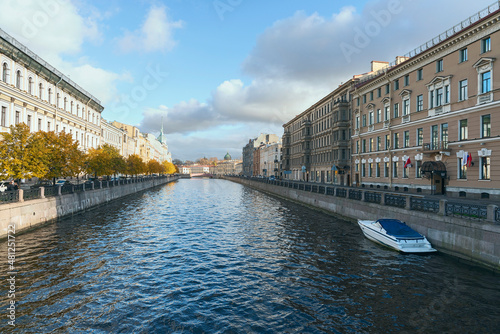 view of the city canal and sports boat against the blue sky in St. Petersburg, Russia