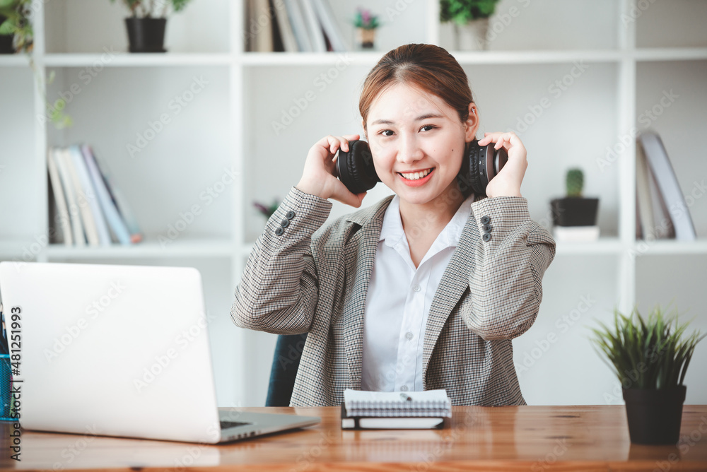 asian girl happy and charming Wear headphones to communicate by video conferencing at your desk. Using a laptop computer, video chat asian girl happy and charming Wear headphones to communicate by video conferencing at your desk. Using a laptop computer, video chat
