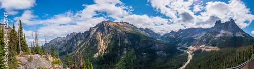 A panoramic view of the North Cascades from the Washington Overlook on a cloudy day with mountains in the background