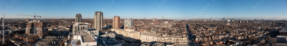 Downtown Toronto Panorama  cityscape  with the construction of building and crane in view as well as Lansdowne and DuPont area Campbell Park  with hockey Rink   and Cn tower and Toronto buildings   