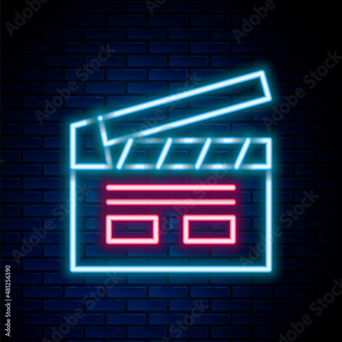 Glowing neon line Bollywood indian cinema icon isolated on brick wall background. Movie clapper. Film clapper board. Cinema production or media industry. Colorful outline concept. Vector