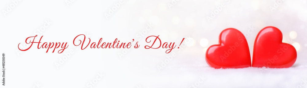 Fototapeta premium Two red hearts on a white background with bokeh. Postcard for Valentine's Day.Banner.Happy Valentine's Day