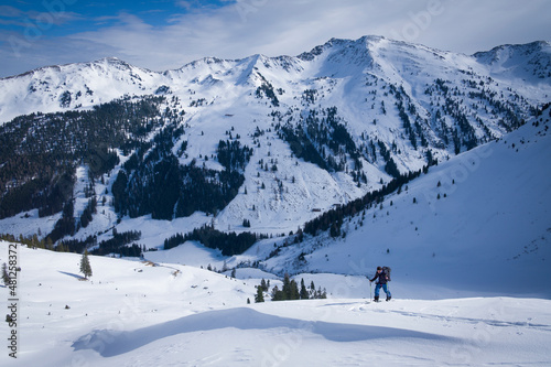 Person in snow on skitour on the mountain top of Mareitkopf in Alpbachtal in Austria.