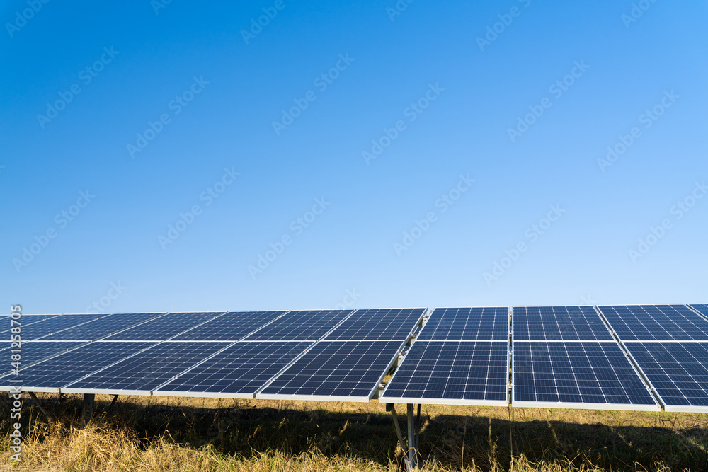 Solar panels in the countryside. Innovation plant of creating ecological energy at daytime. Eco light from solar panels concept Solar panels in the countryside. Innovation plant of creating ecological energy at daytime. Eco light from solar panels concept