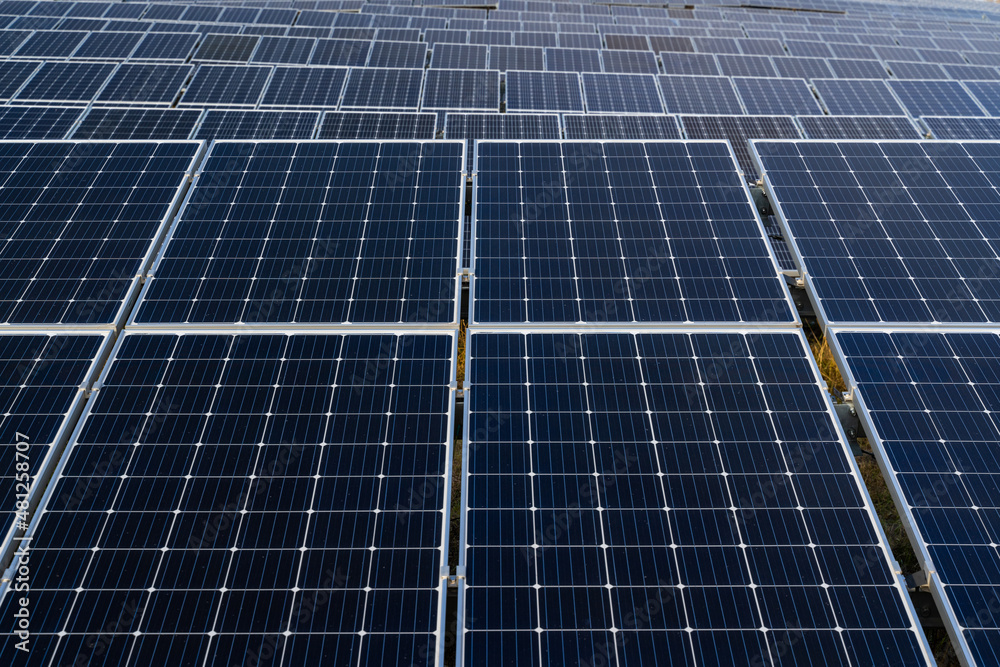Solar panels farm field of green renewable energy. Powerful station with solar panels generates electric current with help of sunlight on field Solar panels farm field of green renewable energy. Powerful station with solar panels generates electric current with help of sunlight on field