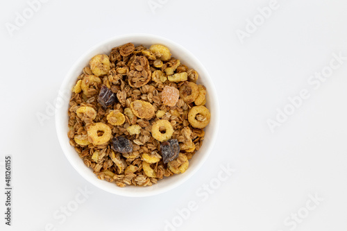 crunchy granola in bowl isolated on white background