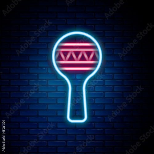 Glowing neon line Maracas icon isolated on brick wall background. Music maracas instrument mexico. Colorful outline concept. Vector