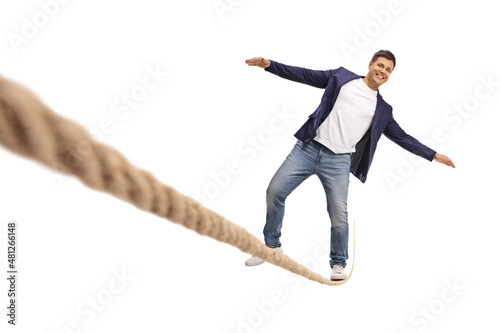 Quadro em tela Full length portrait of a smiling young man walking over tightrope