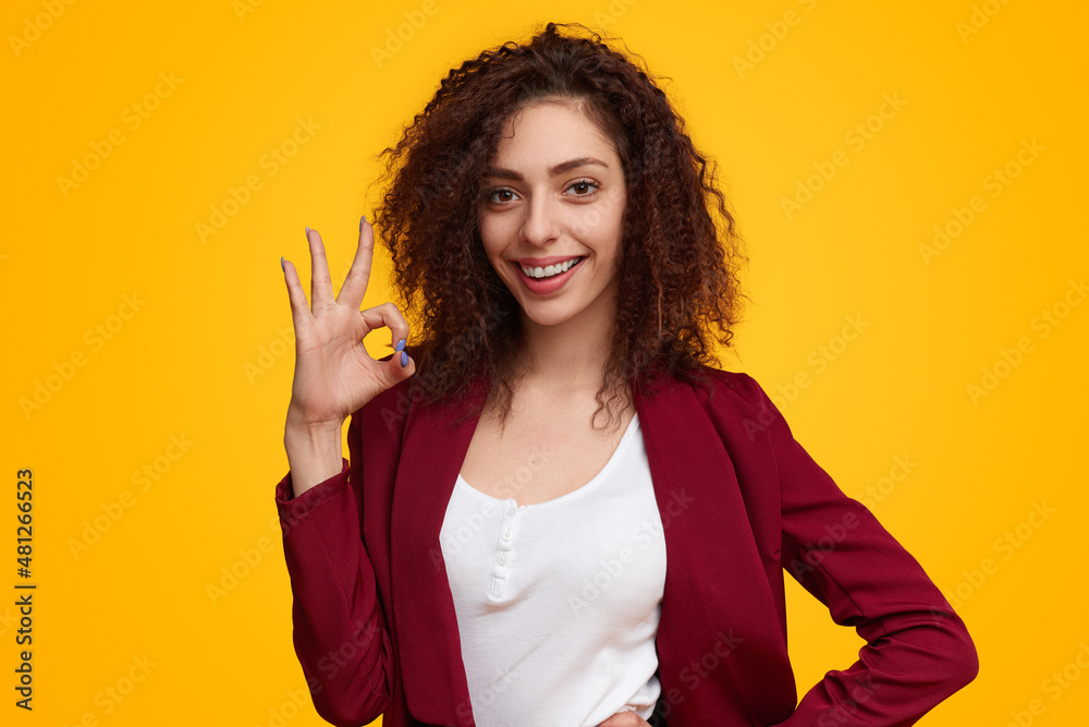 Smiling woman showing Ok gesture Smiling woman showing Ok gesture