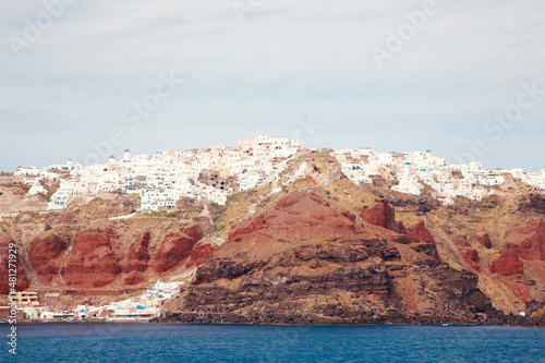 View from Water of Greek Village and Rock Strata on Top of Calde