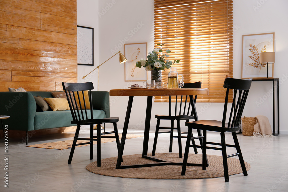 Stylish apartment interior with dining table and other furniture Stylish apartment interior with dining table and other furniture