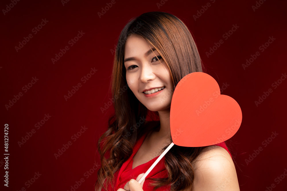 Valentine's Day. Smiling beauty girl long brown hair holding Valentine red hearts on red background. Valentine's Day. Smiling beauty girl long brown hair holding Valentine red hearts on red background.