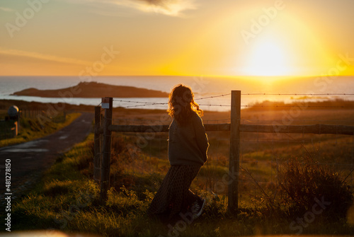 Girl in back light sunset in Autumn with a island in background © Paulo Esteves