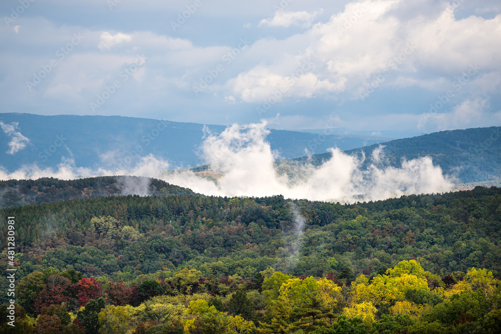 Morning fog clouds sky weather dramatic rising mist in early fall autumn foliage season on road to Dolly Sods, West Virginia mountains near Wardensville, WV