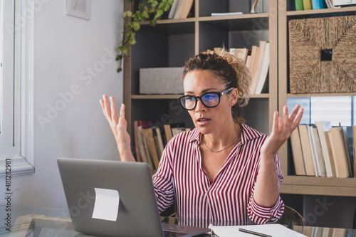 Disappointed female employee confused with bad internet connection or laptop breakdown at office. Frustrated businesswoman puzzled facing device operating problem at home work desk